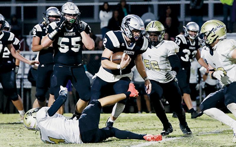 Black Knights senior Chase Calhoun leaves Hayesville’s Isaac Chandler lying in his wake Friday, while attempting to navigate through the Jackets defense. Calhoun later reeled in a 60-yard touchdown pass in the third quarter of Robbinsville’s 26-20 triumph. Photo courtesy of Miranda Buchanan/Robbinsville High School Yearbook