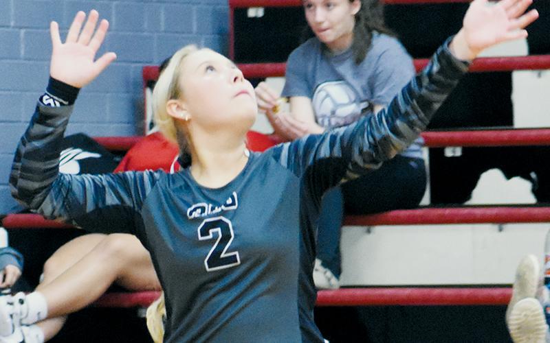Sophomore libero Suri Watty eyes a serve during  Tuesday’s conference-tournament semifinals against Swain County. Watty’s stint at the service line in the third set sparked a 12-3 run for Robbinsville. Photo by Kevin Hensley/sports@grahamstar.com