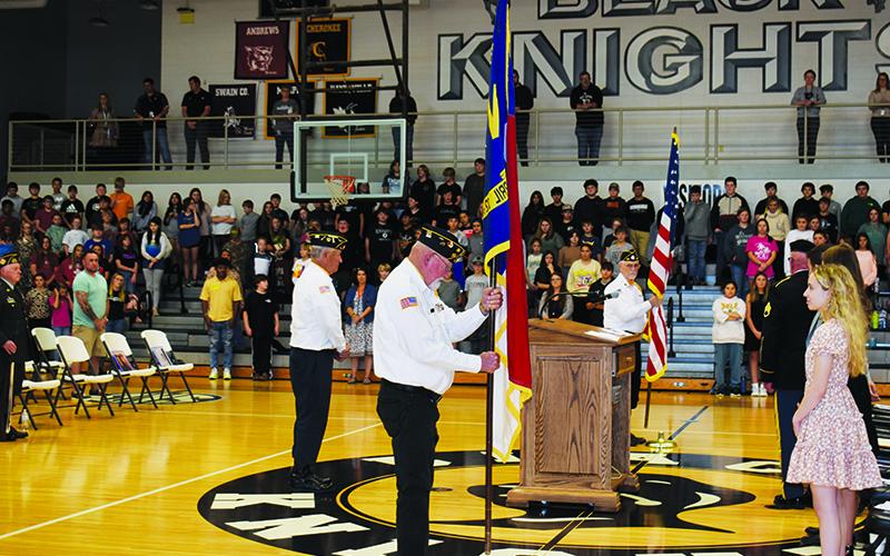 Members of both the Veterans of Foreign Wars Post No. 8635 and American Legion Post No. 192 begin the retiring of colors to wrap up Nov. 10’s Veterans Day recognition at Robbinsville High School. Photo by Ruby Annas/news@grahamstar.com