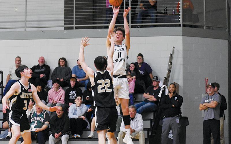 Black Knights senior Donovan Carpenter unloads a  corner jumper during the second half of Friday’s win over Hayesville. Carpenter’s 14-point evening led Robbinsville’s output. Photos by Fala Welch/The Graham Star