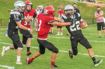 Andrews' Gage Gillespie (3) meets the stiff-arm of Robbinsville's Rylee Anderson during Friday's scrimmage at Big Oaks Stadium.