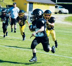 Conner Hyde finds some real estate during PeeWee action at Murphy on Saturday. Photo by Jenny Millsaps
