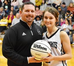 Following Monday’s win, the Robbinsville Lady Knights recognized senior Cambrie Lovin for scoring her 1,000th career point during the KSA Christmas Tournament in Orlando on Saturday, Dec. 28. With Lovin is Lady Knights head coach Lucas Ford. Photo by Kevin Hensley/editor@grahamstar.com