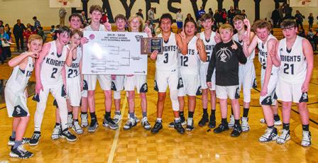 The Robbinsville Middle School Black Knights pose with the 2019-20 championship tournament bracket, moments after defeating the Hiwassee Dam/Ranger Eagles to win the title on Jan. 23 in Hayesville. From left are Dane Knott, Roman Jones, Luke Lovin, Tytan Teesateskie, Donovan Carpenter, Bryce Adams, Zeke Silvers, Xander Wachacha, Quinn Jumper, Andrew Scrivner, Drake Anderson, Austin Colangelo, Hugh Forbes and Isiac Collins. Photos by Byron Housley/The Graham Star