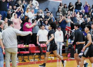 The Black Knights erupt, moments after Robbinsville’s Darion Ledbetter hit the buzzer-beating winner Friday at Andrews. Photos by Kevin Hensley/sports@grahamstar.com