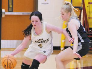 Sophomore guard Suri Watty (right) keeps a watchful eye on the outside antics of Hayesville’s Breanna Abrams during Tuesday’s loss in the semifinals of the conference tournament at Cherokee. Photos by Kevin Hensley/sports@grahamstar.com