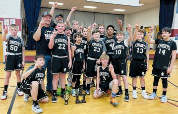The Robbinsville Mites gather at the conclusion of Saturday’s league tournament, to relish in the moment of winning the 2023-24 title. Kneeling in front are Channing Mull (left) and Brayden Allison. Second row (from left) are Jed Baxter, Micah York, Draylen Hill, Dex Webster, Conner Hyde, Tanner Fouts and Elijah Millsaps. Third row (from left) are assistant coach James York, Carsan Snider, Hudson Blevins and David Guzman. Back row (from left) are head coach Corey Snider, Tyler Holder and Levi Satterfield.
