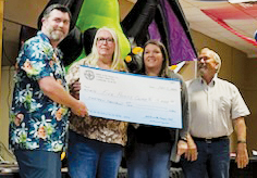 Five Point Center's Michelle Shiplet and Misty Shope (center) accept a check for $13,000 from MINIs on the Dragon. The funds were raised during this year's annual MINIs stint in Graham County.