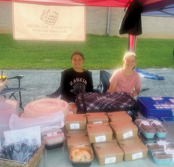 Calista Holder (left) and Elodie Phillips provide sweet delicacies at “Taste the Goodness.”