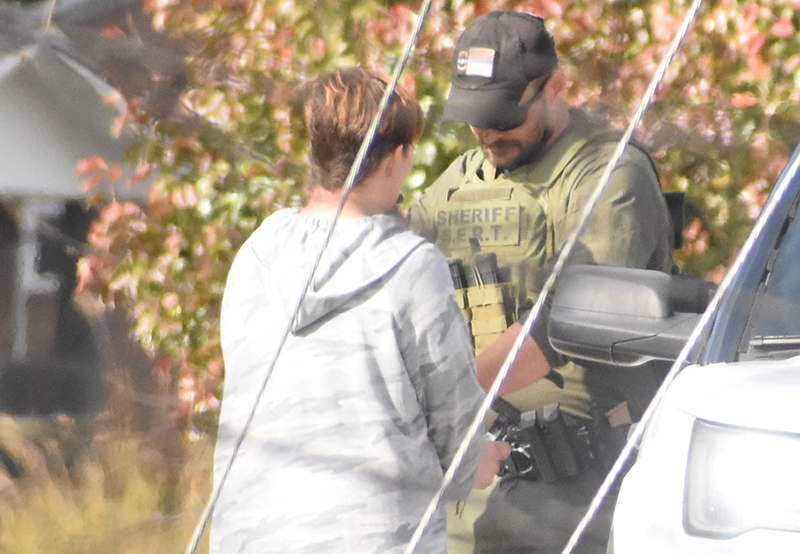 Graham County Sheriff's Office Deputy Jarod Lovelace encounters one of the individuals authorities were searching for around 1 p.m., Nov. 26, as part of  "Operation Dirty Laundry: Phase 2." The suspect was apprehended just outside the Robbinsville city limits, after being spotted on foot walking north off U.S. Highway 129 (Tapoco Road). Photo by Kevin Hensley/editor@grahamstar.com
