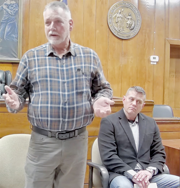Sheriff candidate Mitch Millsaps answers a question during Saturday's forum. Candidate Terry Grey is seated next to Millsaps, waiting to answer the same question.