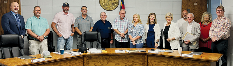 Members of both the Graham County boards of commissioners and education gathered shortly after a contract was signed Tuesday to allow the county to purchase school-owned property in order to construct a justice center. From left are school board attorney John Henning, commission Vice Chair Lynn Cody, commissioner Jacob Nelms, school board member Corey Snider, school board Chair Rodney Nelson, school board Vice Chair Chip Carringer, Commission Chair Meggan Smith, commissioners Natasha Williams and Connie Orr, Superintendent Robert Moody, county attorney Jay Coward, County Clerk Kim Crisp and County Manager Brady Cody.