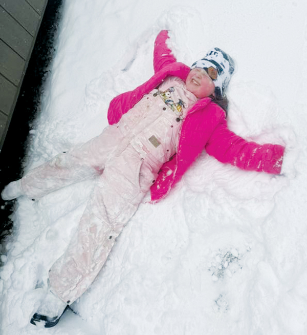Eight-year-old Nova Guy braved the elements to make a snow angel outside her Snowbird home over the weekend. For more snow photos, turn to page 2.