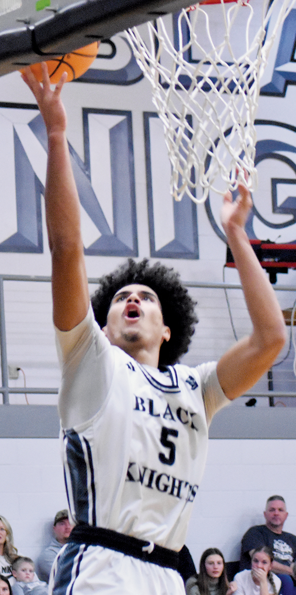 All alone at the net, Knights senior Darion Ledbetter measures a lay-up attempt Friday against Murphy. Photo by Kyla Garland/The Graham Star