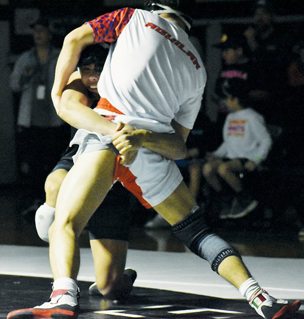 Adair Panama applies a low waist-lock on Glenn’s Yusel Aguilar en route to winning the 113-pound weight class Saturday.