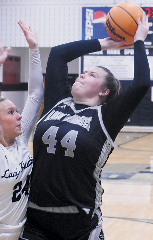 While being guarded by North Buncombe’s Gracie Edmonds, Robbinsville’s Bentley Riggins muscles her way into the paint.