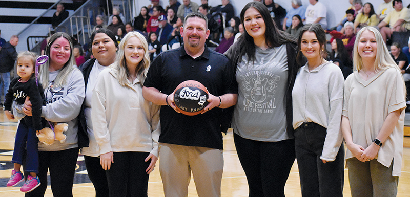 The impact Lucas Ford has made on the sports scene at Robbinsville High School cannot be underscored. After taking over as head coach of the varsity girls team prior to the 2017-18 season, he was recognized for his contributions to the Lady Knights basketball program prior to Tuesday’s home game against Cherokee. Photo by Bella Eddings/The Graham Star
