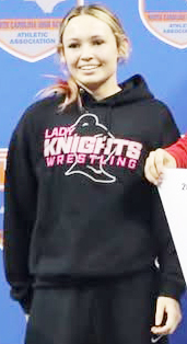 Myah Winfrey stands on the awards podium Friday, after finishing third in the 1A-4A state individual tournament.