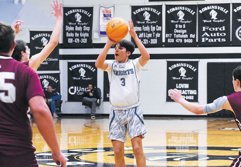 Xamuel Wachacha takes aim from the top of the key in Friday’s blowout victory over Swain County. Photo by Jacquline Gayosso/The Graham Star