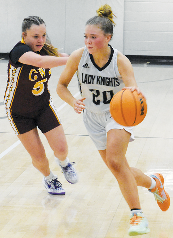 Junior varsity Lady Knight MyKayla McGuire cuts around a Cherokee defender and toward the paint late in Monday’s quarterfinal game with the Lady Braves.