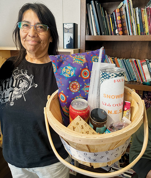 Kathy Johnson displays one of the gift baskets afforded to tribal visitors from Oklahoma on April 29.