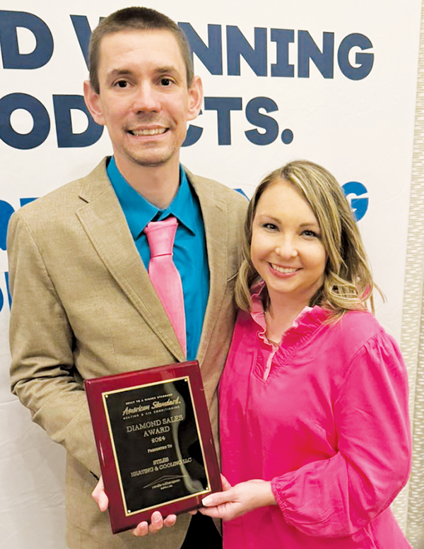 Eddie and Hannah Stiles show off their Diamond Sales Award from American Standard, which the owners of Stiles  Heating and Cooling received at a March conference in Wilmington.