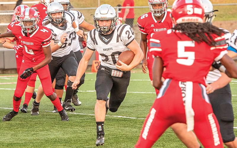 Robbinsville's Lex Hooper (20) quickly reminded Erwin and any future opponents that there is more than one dangerous running in the Black Knights' backfield Friday night, as he caught the Warriors defense completely off-guard on the first play of the game and easily found some open room for a 65-yard touchdown as a result. Photo by Byron Housley/The Graham Star