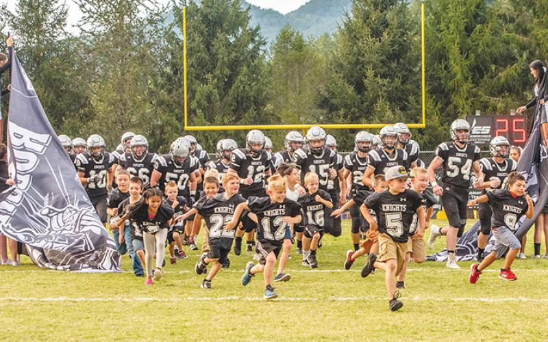 Summer youth football camp participants led the Black Knights onto the field during Youth Night on Friday. Photos by Byron Housley/The Graham Star