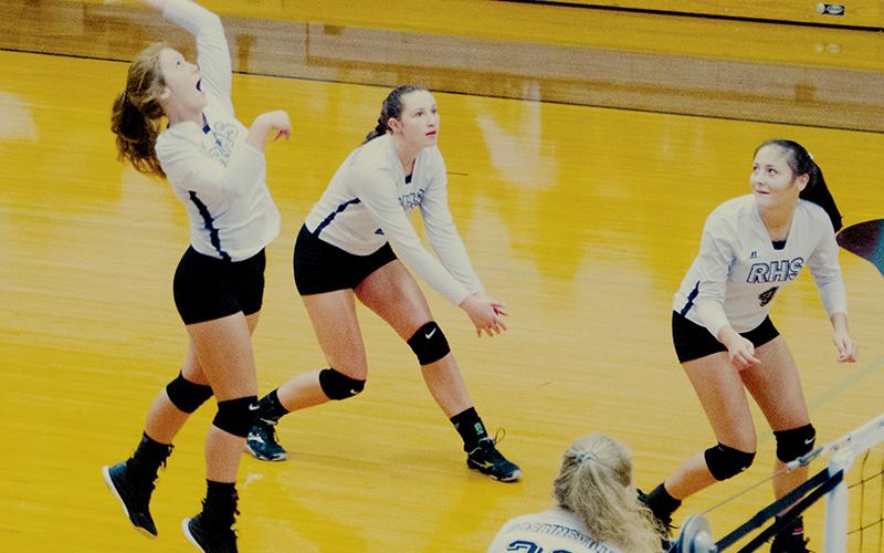 Surrounded by teammates Karlyn Matheson, Kennedy Cable (4) and Karcee Dooley (22), Lady Knights sophomore Halee Anderson prepares to spike the ball during Tuesday’s sweep against Andrews. Now 12-1 on the year, Robbinsville has moved into the No. 1 state ranking for all 1A schools. Photo by Kevin Hensley/editor@grahamstar.com