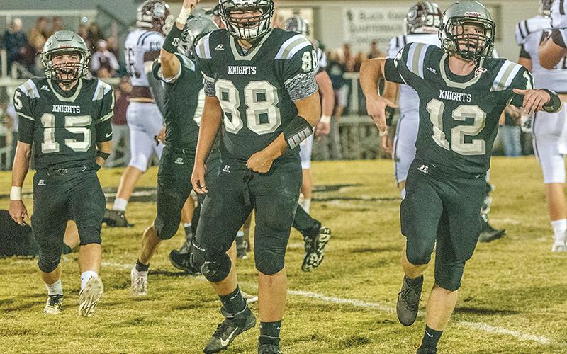 Black Knights Clayson Lane, Rossi Wachacha and Kamron McGuire (from left) were pumped up after Candler Edwards recovered a Swain County fumble during the first quarter of Monday’s 43-6 win over the Maroon Devils. Photos by Byron Housley/The Graham Star