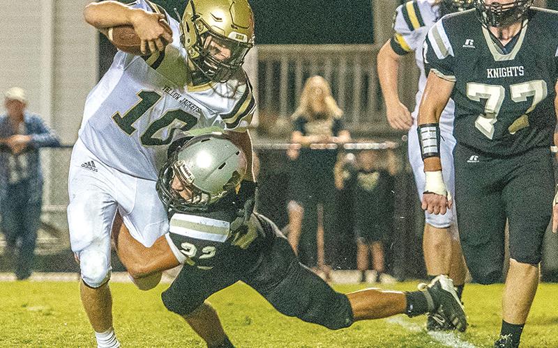 Robbinsville senior Rylee Anderson (22) drops Hayesville quarterback Hayden McClure for a sack during Friday’s 55-10 win over the Yellow Jackets. Photo by Byron Housley/The Graham Star