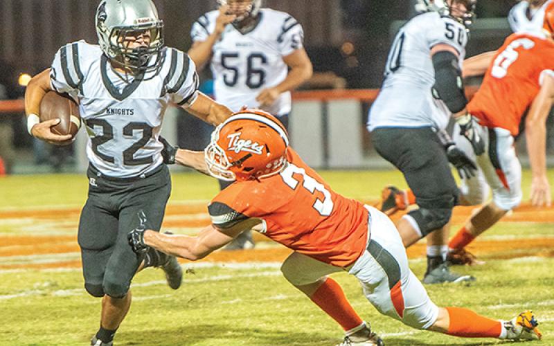 Robbinsville senior Rylee Anderson (22) dashes the hopes of Rosman's Thomas Collins on a big gain Friday. Anderson surpassed the 5,000 career-yards mark during the game. Photo by Byron Housley/The Graham Star