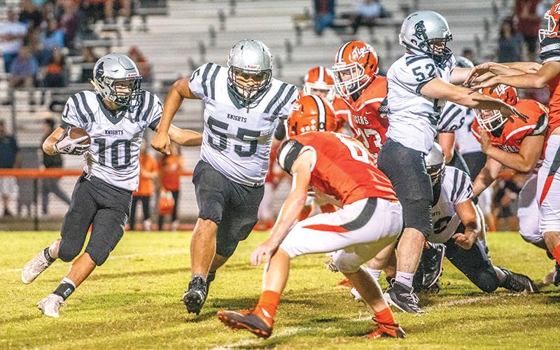 With Xavier Rattler (55) and Stewart Carver (52) clearing a path, Robbinsville’s Wade Hamilton (10) makes his way to the end zone for the final Black Knights touchdown of Friday’s conference opener at Rosman. Photos by Byron Housley/The Graham Star