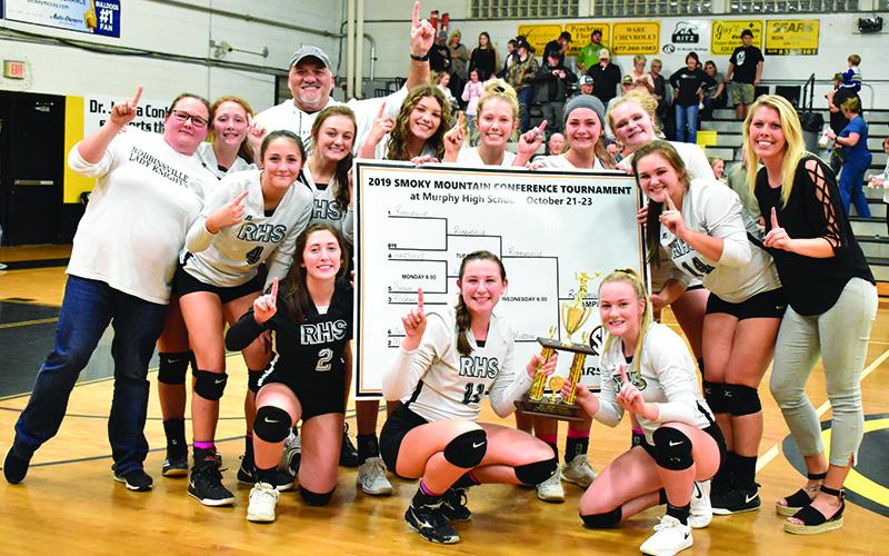 The Robbinsville Lady Knights won their first-ever Smoky Mountain Conference tournament championship Wednesday night, sweeping co-division champions Murphy in the finals. Kneeling in front (from left) are Gabby Hooper, Karlyn Matheson and Liz Ayers. Standing in back (from left) are assistant coach Dede Brooms, Halee Anderson, Kennedy Cable, coach James Keefer, Ally Ayers, Yeika Jimenez, Kensley Phillips, Gracye Burchfield, Karcee Dooley, Ivy Odom and head coach Kadey Phillips.