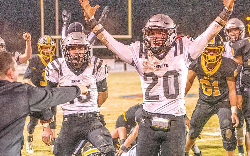 Coach Lucas Ford (left) can't contain his excitement as Clayson Lane (15) and Lex Hooper (20) rejoice in the moment Friday night at Murphy, after Robbinsville moved the chains for the final time in a Smoky Mountain Conference title-clinching 17-14 win over the Bulldogs. Photos by Byron Housley/The Graham Star