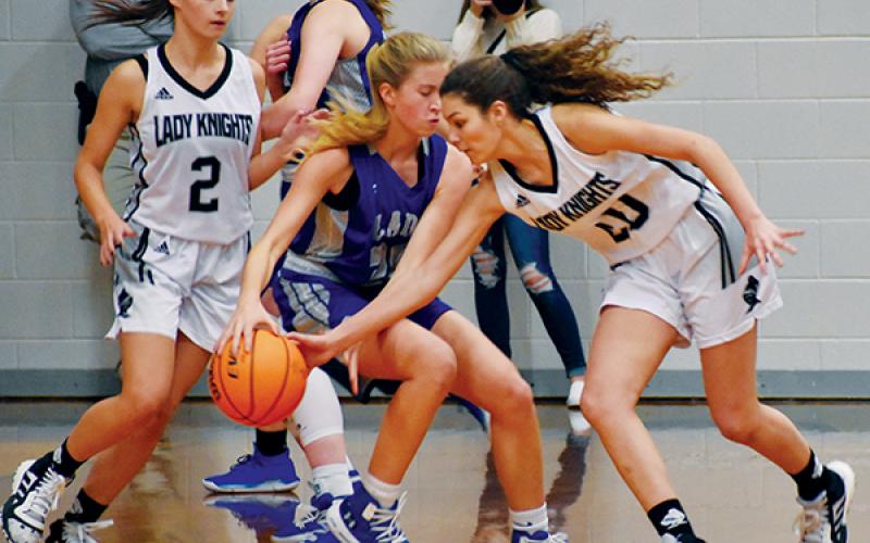 Robbinsville’s Yeika Jimenez (20) swats the ball out of the hands of Smoky Mountain’s Natalie Passis during the Dec. 19 home opener. Photo by Kevin Hensley/editor@grahamstar.com