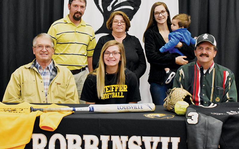 Lady Knights senior Gracye Burchfield (seated, center) signed with Pfeiffer University on Dec. 4. Seated with Burchfield are Larry Icenhower (left) and Gary Icenhower. Standing in back (from left) are Brent Icenhower, Barbara Icenhower, Hannah Lewis and Jordan Lewis. Photo by Kevin Hensley/editor@grahamstar.com
