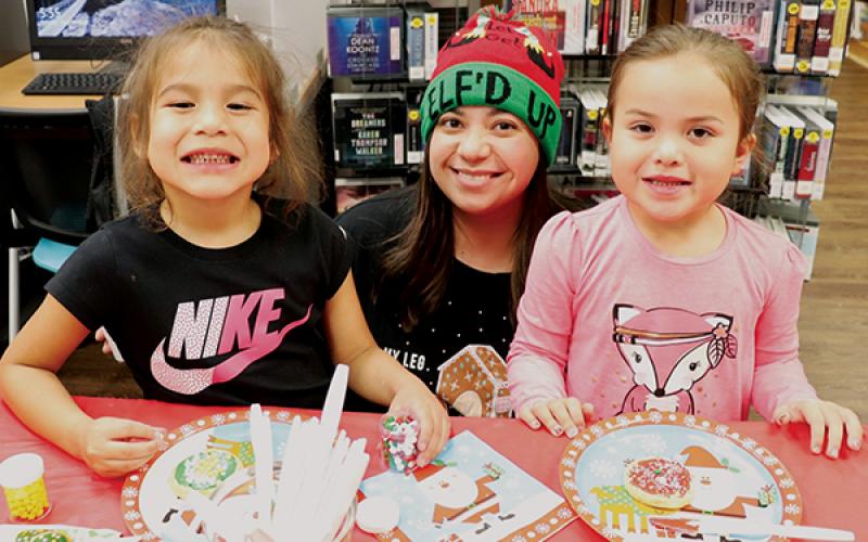 Bennett Brown (left) and Woodleigh Welch worked with Kari Beth Holloway (center) to create the perfect Christmas cookie at Snowbird Community Library’s Cookie and Ornament Decorating Party on Dec. 10. Photo by Zena Rattler/Contributing Photographer