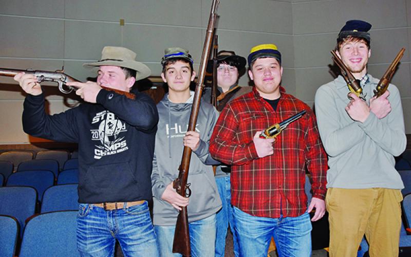 Lex Hooper, Wade Hamilton, Samson Jones Candler Edwards and Drey Keener (from left) handle some weaponry, which was part of the Civil War unit at Robbinsville High School on Monday. Photos by Art Miller/amiller@grahamstar.com
