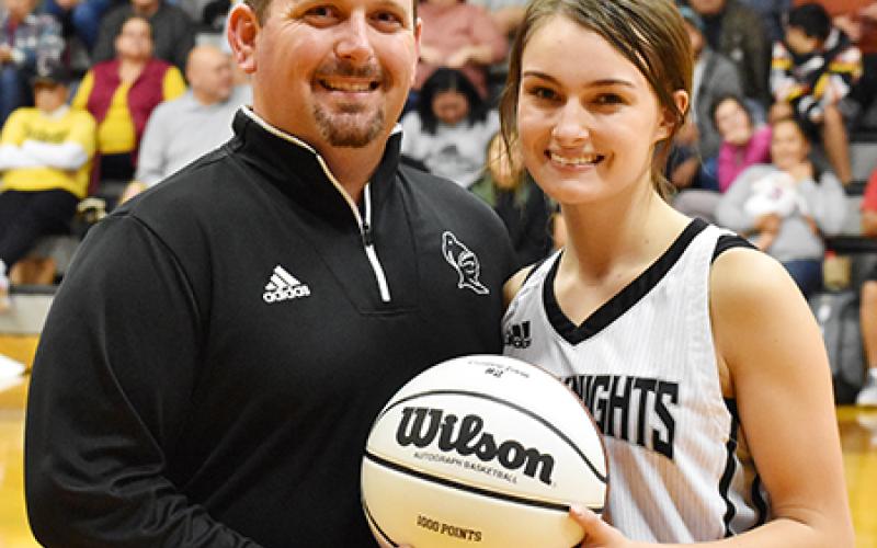 Following Monday’s win, the Robbinsville Lady Knights recognized senior Cambrie Lovin for scoring her 1,000th career point during the KSA Christmas Tournament in Orlando on Saturday, Dec. 28. With Lovin is Lady Knights head coach Lucas Ford. Photo by Kevin Hensley/editor@grahamstar.com