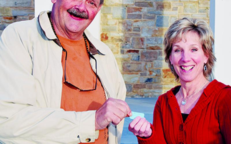 Robbinsville Mayor Steve Hooper congratulates Kim Lequire for winning the REVVED UP Rifle Raffle.