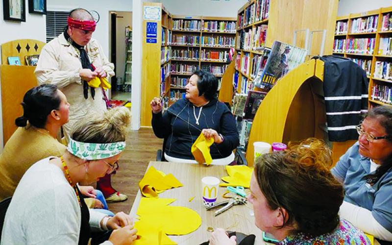 Amateur cordwainers recently gathered at the Snowbird Community Library to make moccasins. Clockwise from top middle are Candy Wachacha-Crowe, Jennifer Wachacha, Robbi Pounds, Kasey Frazier, Paige Wachacha Gross and Michael Crowe. Photo by Art Miller/amiller@grahamstar.com