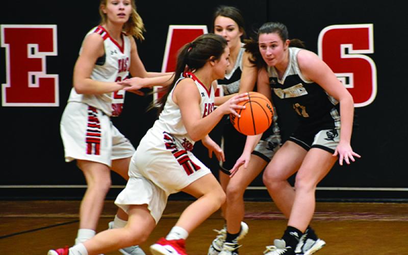 Robbinsville seniors Cambrie Lovin (left) and Karlyn Matheson eye an East Surry player during Thursday's game in Pilot Mountain. Photo by Kevin Hensley/editor@grahamstar.com