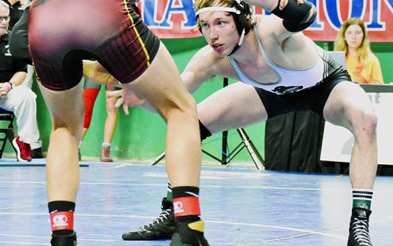 Justin Stewart  hand-fights with South Stokes’ Kaleb Mitchell during the 160-pound consolation semifinals Saturday.