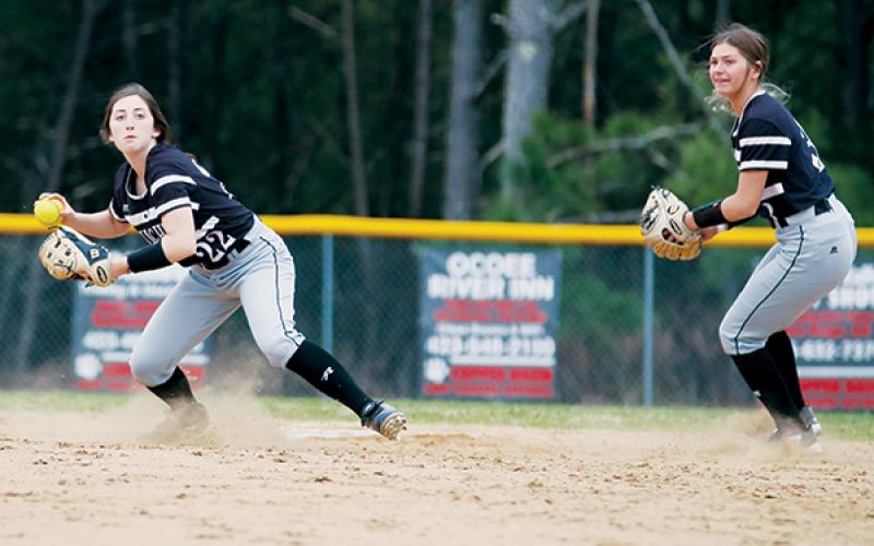 With Gracye Burchfield (right) backing her up, Robbinsville's Gabby Hooper eyes a putout during Monday’s season-opening victory at Copper Basin.