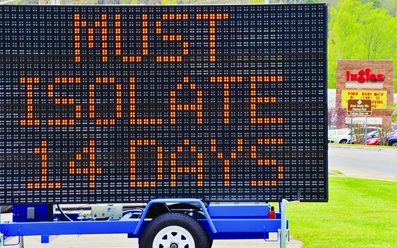 This electronic sign sits in the Quality Inn parking lot and greets visitors as they enter Robbinsville, providing instructions on protocol should visitors wish to stay in Graham County. The sign is 1-of-3 placed throughout the county and was approved by the Graham County Emergency Management Coordination Committee during its teleconference Wednesday, April 22. Photo by Art Miller/amiller@grahamstar.com