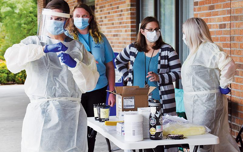 Those wishing to be tested for COVID-19 were able to stop outside the Robbinsville Post Office on Wednesday, Aug. 19. On-hand to help conduct the tests were Hannah Anderson, April Morefield, Emily Collins and Haley Anderson (from left). Photo by Art Miller/amiller@grahamstar.com