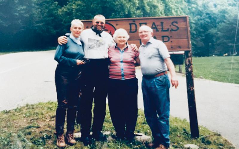 The Leary’s (couple at right) were frequently asked by travelers who stopped at Deals Gap to pause for a photograph in front of the sign outside their store, Crossroads of Time. Photos courtesy of Cathy Mathews