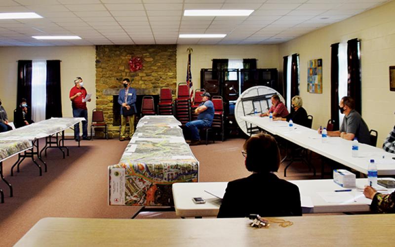 Members of the Graham County Board of Commissioners and public alike listen intently to Dirk Cody’s explanation of the latest plans for Corridor K at Tuesday’s public hearing.