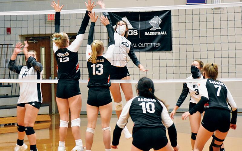 Lady Knights junior Yeika Jimenez (20) closes in on a kill attempt during Monday’s season opener against Rosman. Note athletes on both sides wearing masks, thanks to a recent mandate handed down by the N.C. High School Athletic Association. Photos by Kevin Hensley/editor@grahamstar.com